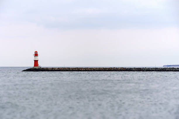 istock Lighthouse On Groyne By Sea Against Sky 651475701
