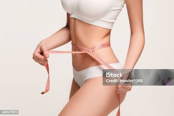 The Girl Taking Measurements Of Her Body White Background Stock Photo - Download Image Now