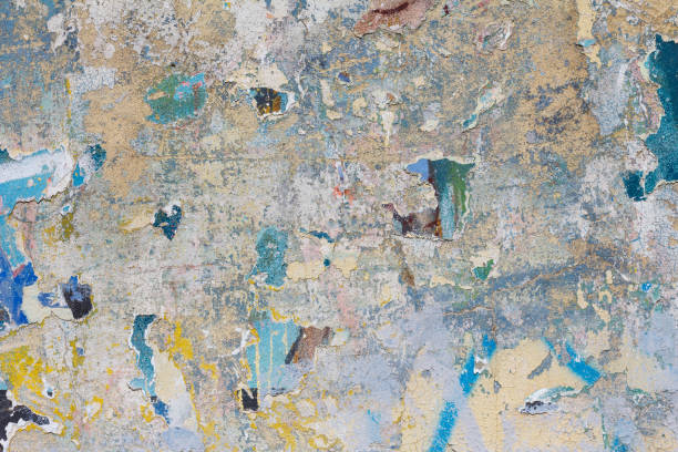 istock Grunge concrete wall with ripped posters 651478872