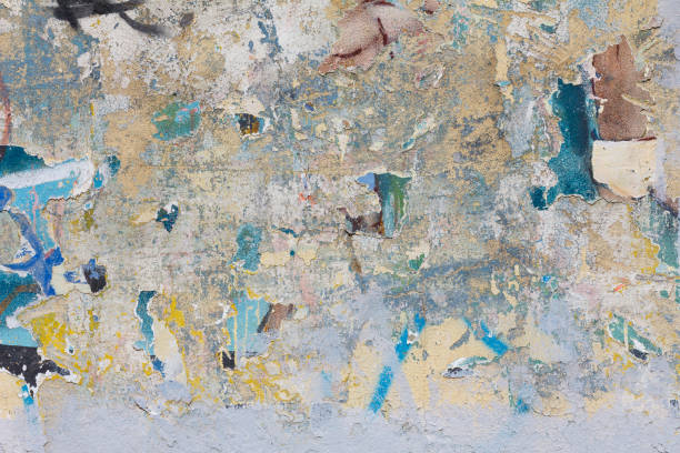 istock Grunge concrete wall with ripped posters 651479340