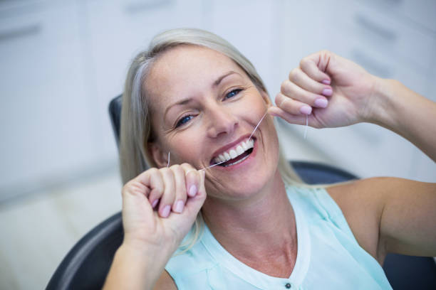 istock Woman flossing her teeth 651479622