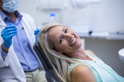 Portrait of female patient smiling in dental clinic