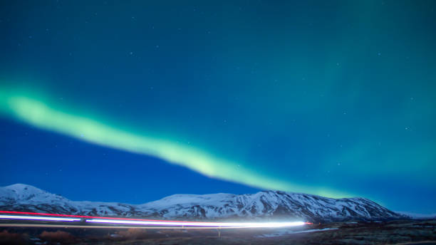 istock Long exposure car's light driving on highway under aurora borealis 651501466