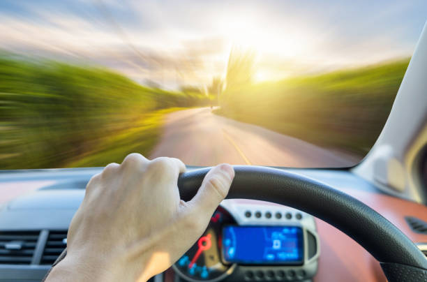 istock Single hand holding right steering wheel driving on motion road sugarcane 651512700