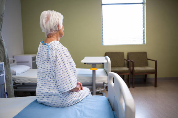 istock Rear-view of thoughtful senior patient sitting on bed 651519620