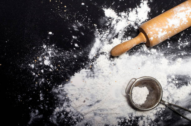 istock Metal strainer and rolling pin with spilling flour 651522780