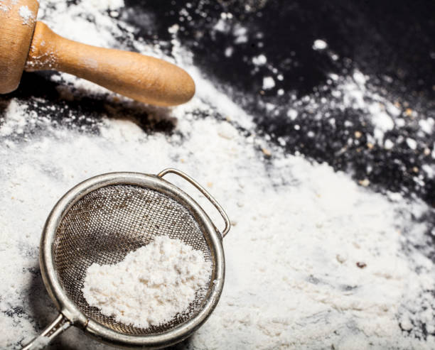 istock Metal strainer and rolling pin with spilling flour 651522860