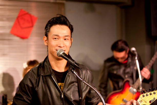 istock Japanese men are singing while playing the guitar 651522952