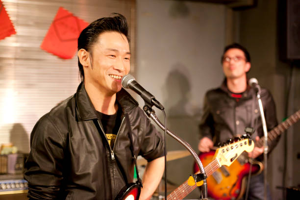 istock Japanese men are singing while playing the guitar 651523000