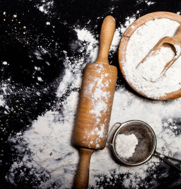 istock Metal strainer, rolling pin and bowl with spilling flour 651523078