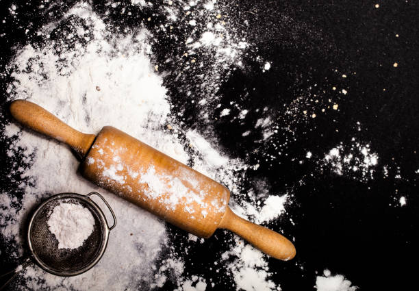 istock Metal strainer and rolling pin with spilling flour 651523144