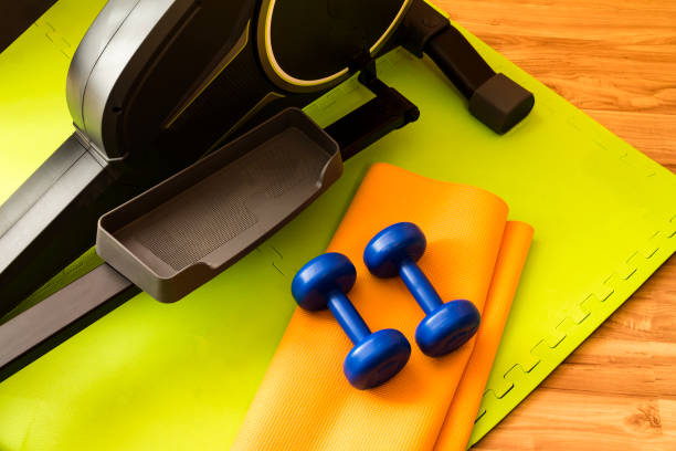 istock equipment for domestic (home) workouts: elliptical trainer, dumbbells 651523596