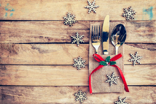 istock christmas table place setting and silverware, snowflakes on table wooden. 651526930