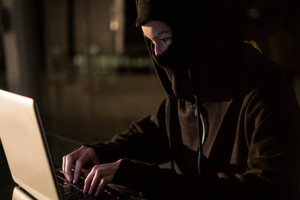 istock Woman in balaclava using laptop 651550460