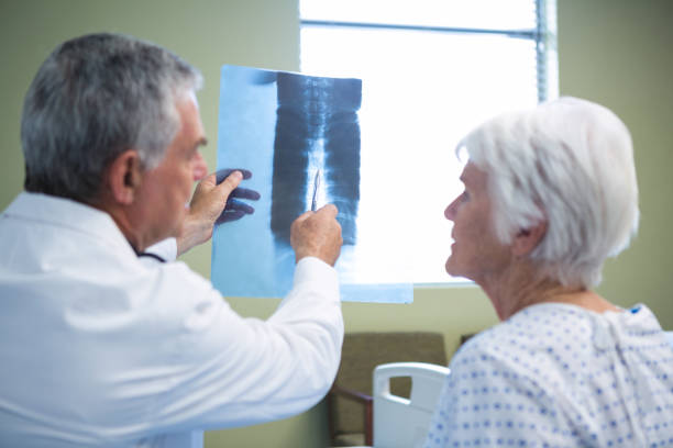 istock Doctor discussing x-ray report with senior patient 651553230