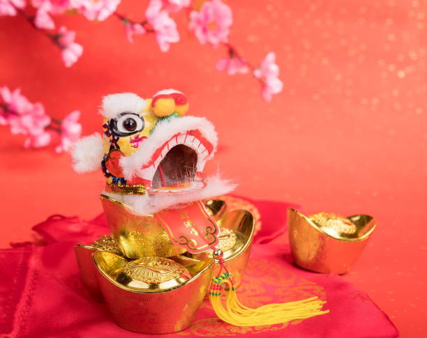istock chinese traditional dancing lion with ingot 651561338