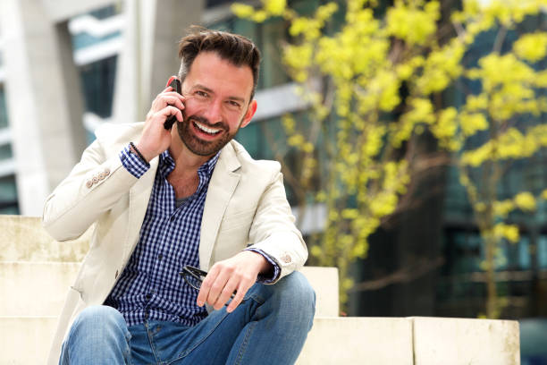 istock Cheerful middle aged man talking on mobile phone 651565946