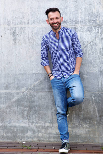 istock Happy mature male model posing against wall 651568416