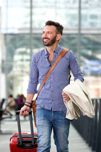 istock Smiling mature man traveling with suitcase 651569696