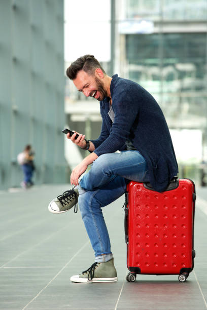 istock Cheerful man waiting at train station 651569900