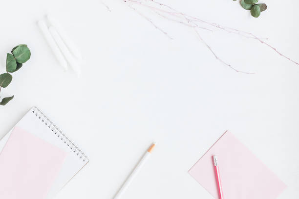 istock Feminine workspace with notebook, paper blank, eucalyptus branches, pencils 651572932