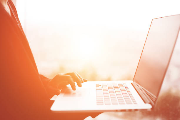 istock Business woman using laptop at sunset 651576590