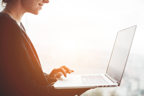 istock Business woman using laptop at sunset 651581820