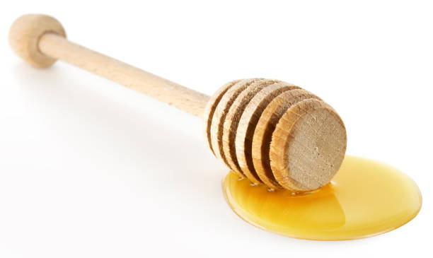 istock honey dipper over a honey drop 651589208