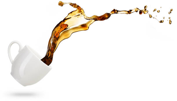coffee spilling out of a coffee cup on white background coffee spilling out of a cup isolated on white background spilling photos stock pictures, royalty-free photos & images