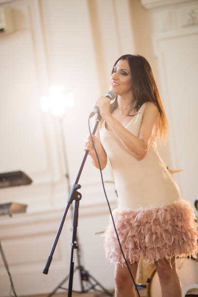 istock Woman singing on the microphone 651592032