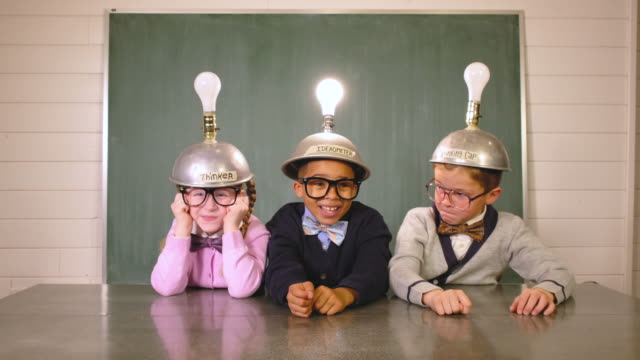 Young Nerds Think while Wearing Idea Helmets