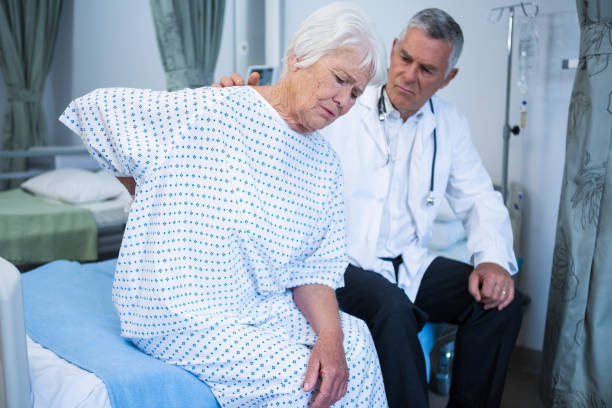 istock Doctor examining senior patient in ward 651641298