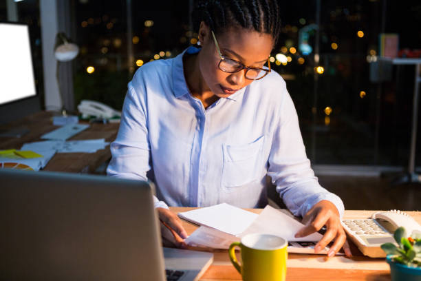 istock Businesswoman reading document at her desk 651653316