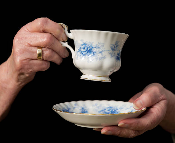 istock Teacup and saucer held in an old woman's hands. 651656338