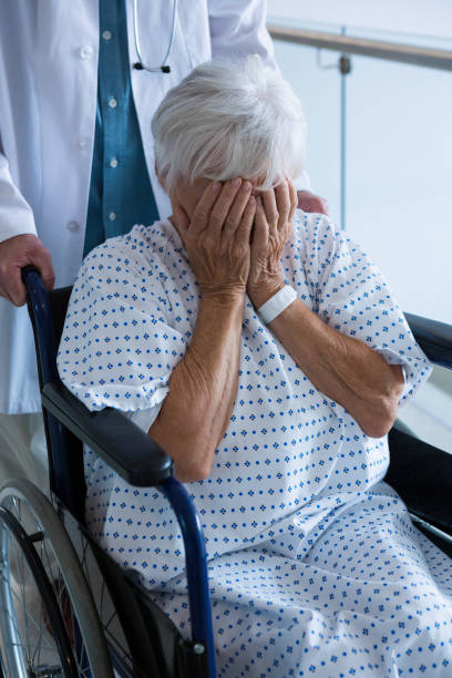 istock Doctor pushing senior patient on wheelchair in passageway 651733850