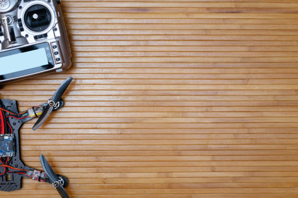 istock remote and the drone on wooden background 651746368