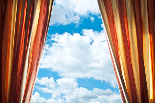 istock Window curtains with view of clouds and sky 651749494