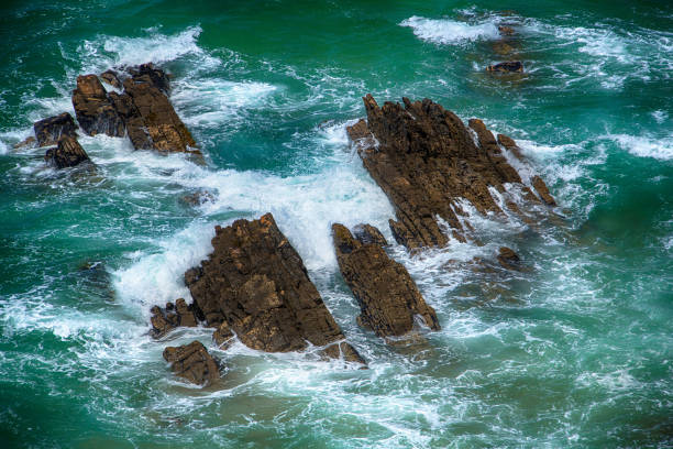 istock Blue raging waves crashing on the rocks 651760438