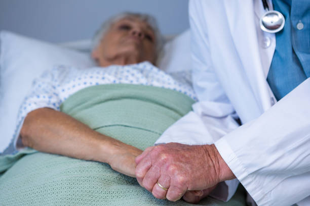 istock Doctor consoling senior patient 651760704