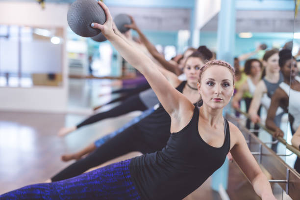 istock Multi-ethnic group of women doing barre workout 651761626