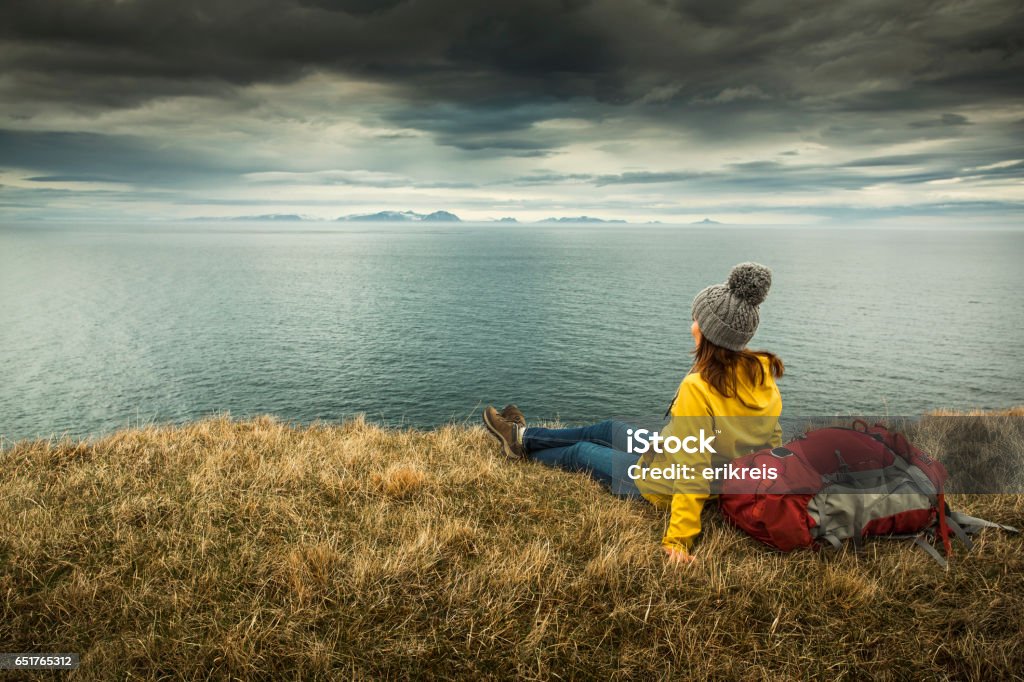 Backpacker Tourist Female backpacker tourist in Icleand resting after a long day of adventures Young Adult Stock Photo