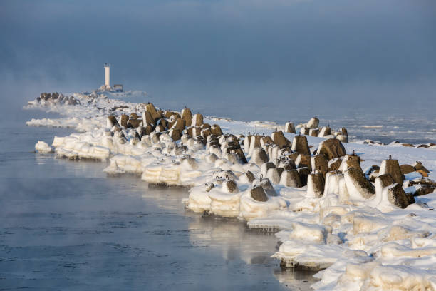 An iced breakwater of embouchure of Daugava  and a lighthouse in the end of it