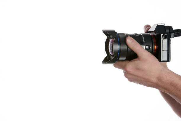 istock Close-up of hand holding camera while isolated on white 651772770