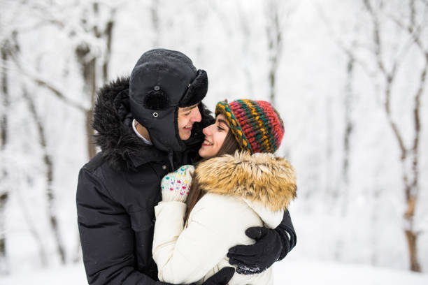 istock Young couple hugging by the river in winter weather 651776574