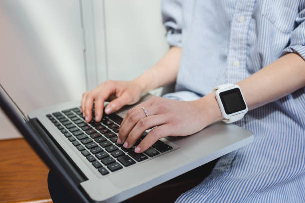 istock Woman using laptop in locker room 651786468