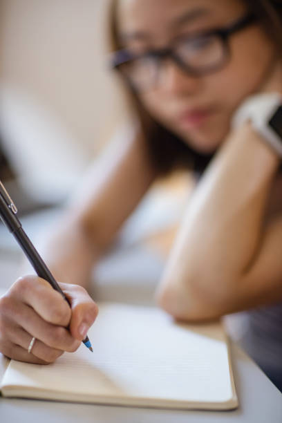 istock Young woman studying in classroom 651788060