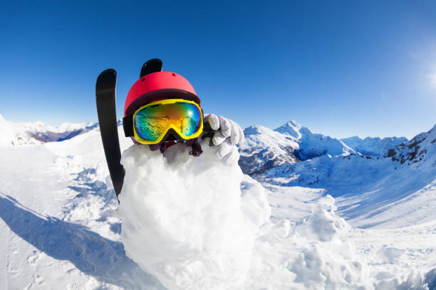istock Snowman in helmet and mask against mountain scene 651788288