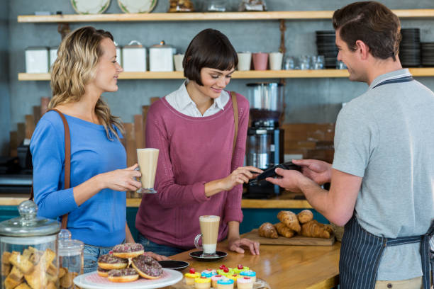 istock Customer making payment through payment terminal at counter 651788550
