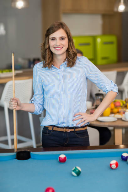 istock Portrait of smiling business executive playing pool 651788554