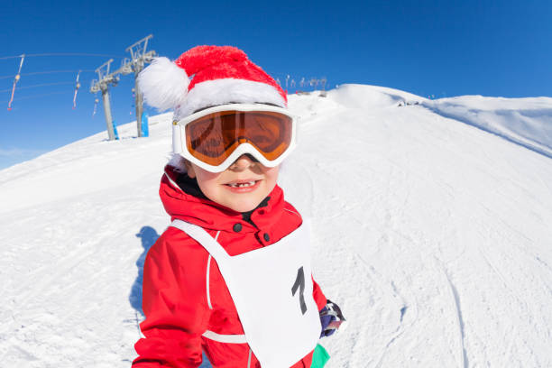istock Cute skier in Santa's hat having fun at snowy hill 651792374